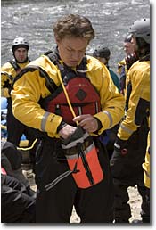 Brian, NW Wholesale Rep, in an NRS Extreme Drysuit, stuffing a throw bag before a spring Lochsa River run.