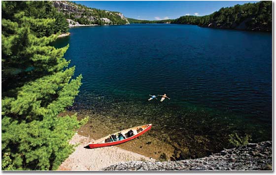 empty canoe on the shore of a lake