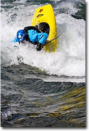 Kayaker hitting a wave